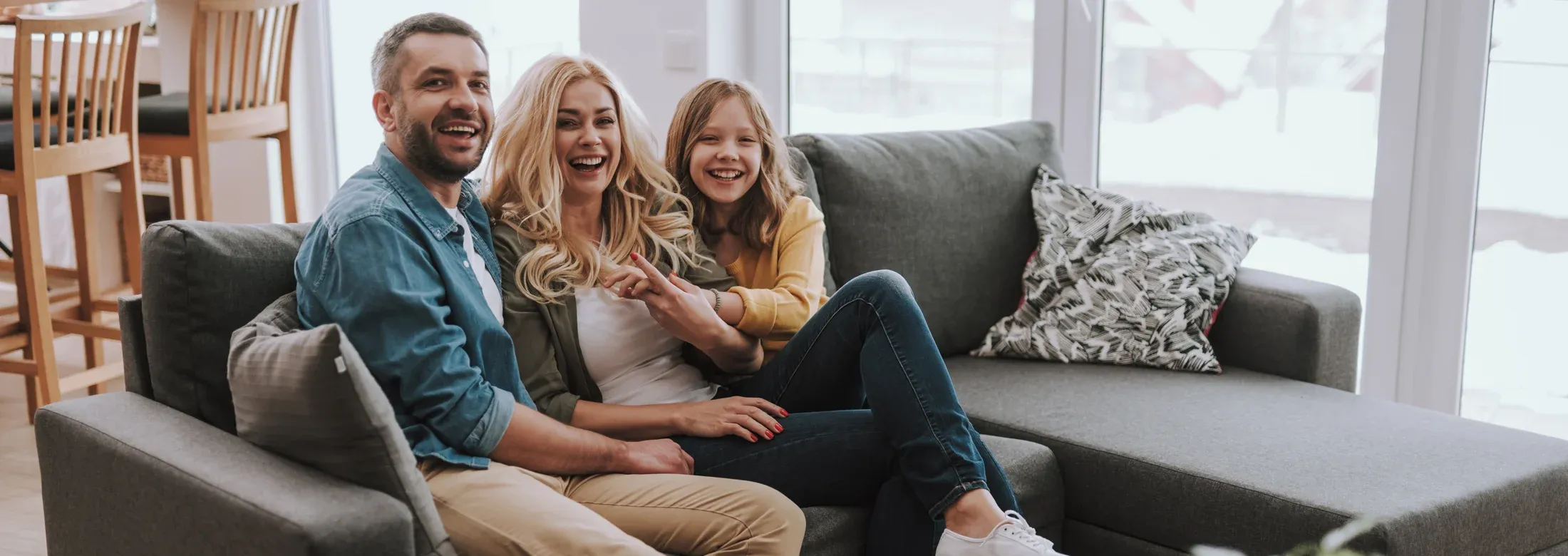 Family sitting and laughing in living room